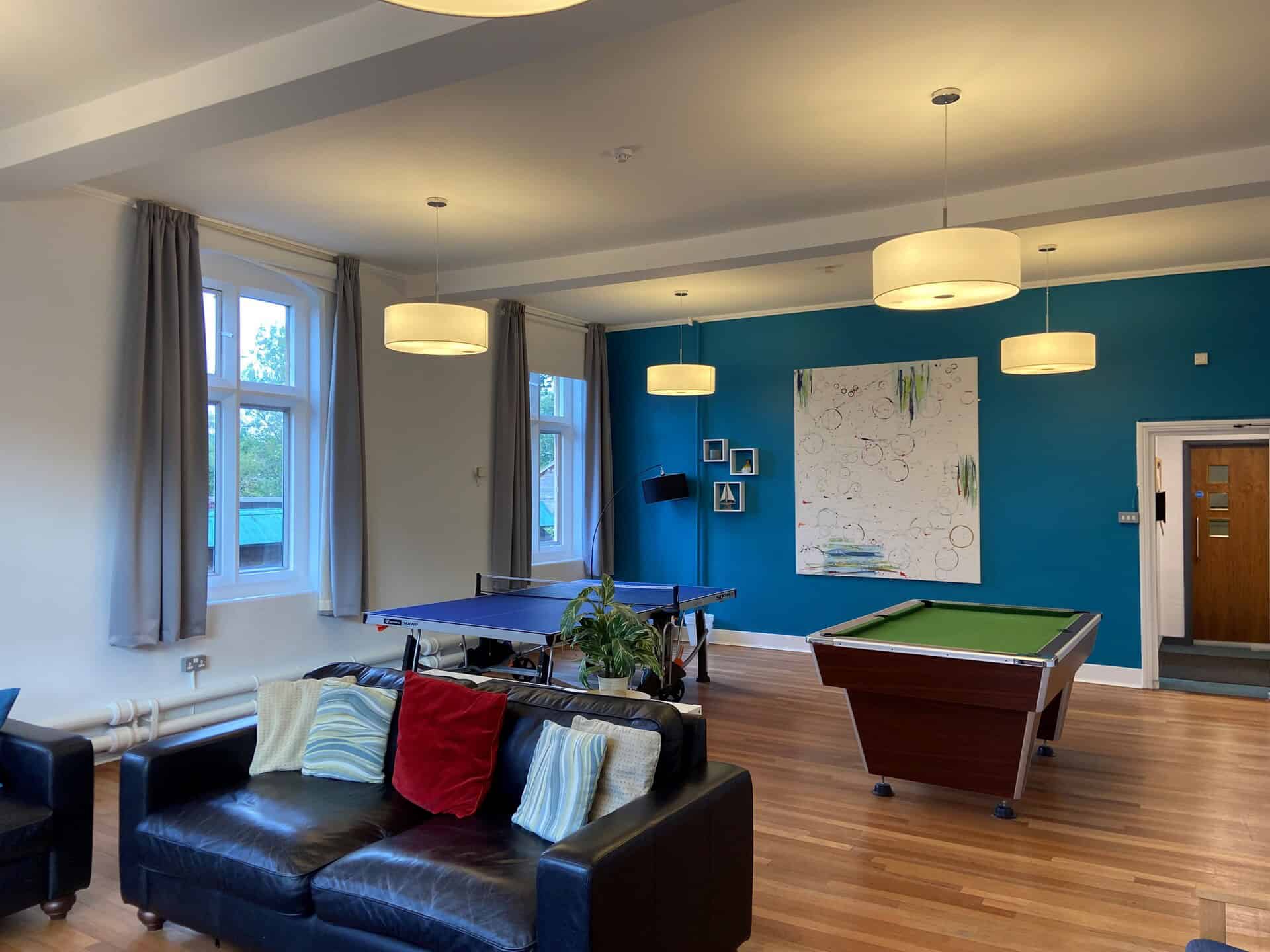 Room with pool table, ping pong table, whiteboard, and sofa